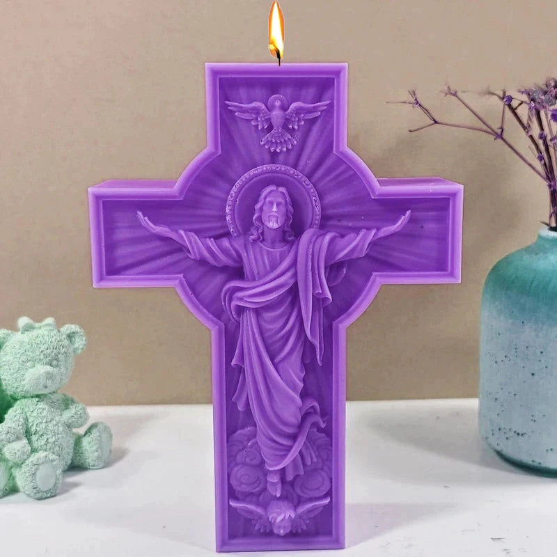 A purple silicone candle mold shaped like a crucifix featuring a depiction of Jesus Christ with outstretched arms.