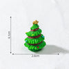 A small, green resin Christmas tree charm with gold star topper and colorful ribbon details.