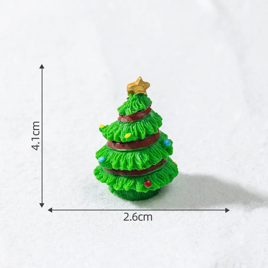 A small, green resin Christmas tree charm with gold star topper and colorful ribbon details.