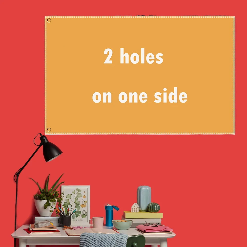 A rectangular orange banner with two holes on one side is displayed on a red wall above a table setting.