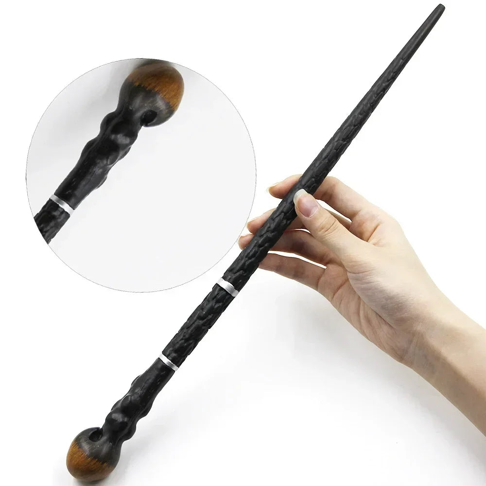 A hand holds a black metal-resin magic wand with a wooden tip and silver accents.