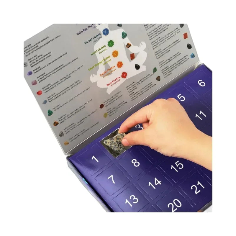 An open advent calendar featuring numbered slots with natural crystal gemstones and text about chakras.