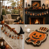 A set of vintage wooden Halloween decorations including pumpkins, ghosts, and moons displayed on a fireplace mantel and a win