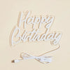 A white LED neon sign shaped like the words Happy Birthday on a light background.