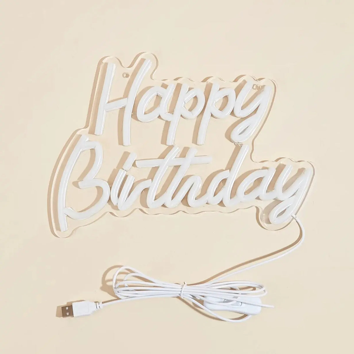 A white LED neon sign shaped like the words Happy Birthday on a light background.