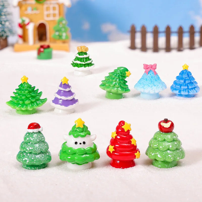 A collection of colorful mini 3D Christmas tree resin charms in various shades of green, blue, and red resting on white snow.