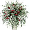 Artificial Norfolk pine branches with green needles and red berry stems used for holiday decoration