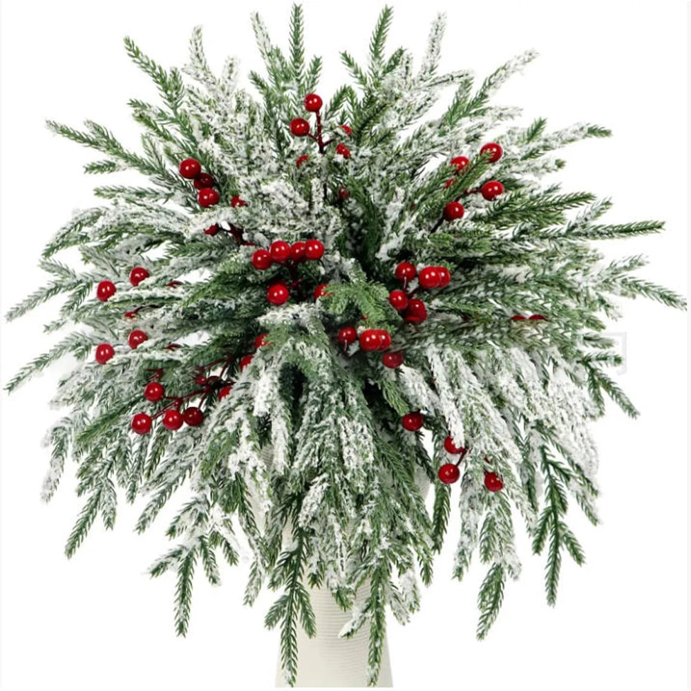 Artificial Norfolk pine branches with green needles and red berry stems used for holiday decoration