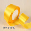 Roll of bright yellow silk satin ribbon for gift wrapping and craft projects