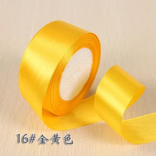 Roll of bright yellow silk satin ribbon for gift wrapping and craft projects