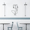 Elegant metal line art wall decor featuring a stylized figure and modern pendant lights above a kitchen or dining area.