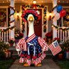 A white goose costume set with red, white, and blue patriotic stripes and stars standing in front of a decorated door.