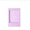 A rectangular pink mini film frame for Fuji Instax instant photos with a silver diagonal cutout.