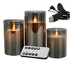 A set of three glass pillar candles with a remote control and power cord for flameless LED lighting.