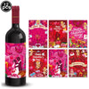 A bottle of red wine next to a set of Valentine's Day themed cards featuring hearts and balloons.