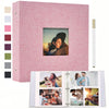 A pink linen scrapbook album with a clear window displaying a photo, next to color swatches and a gold pen.