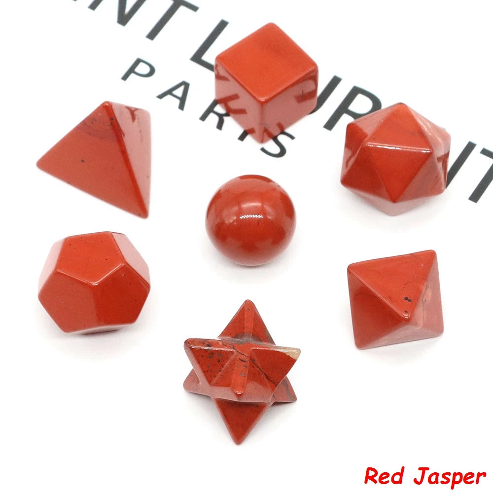 A set of red jasper platonic geometry crystals including cubes, pyramids, and spheres.