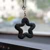 A black rhinestone star charm with crystal accents hanging from a silver chain.