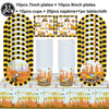 A set of construction vehicle themed birthday party tableware including plates, cups, napkins, and a tablecloth.