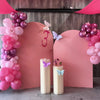 A pink and white balloon party decoration set featuring balloons, pink arches, and decorative elements.