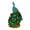 Elegant peacock statue with a blue head and green body featuring crystal tail feathers.