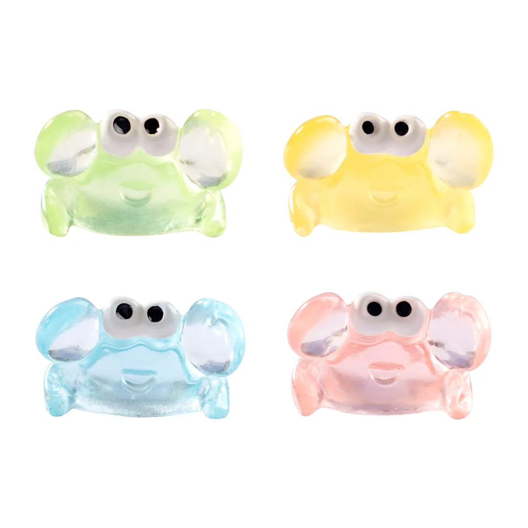 A set of four luminous resin mini crab decor figures in green, yellow, blue, and pink.