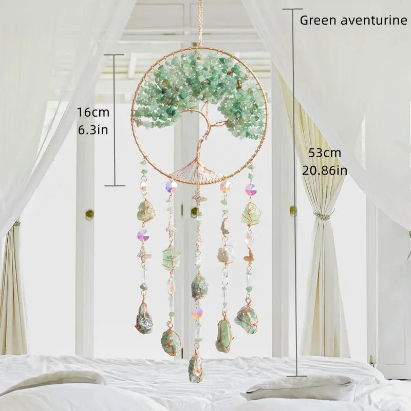 A hanging crystal tree of life sun catcher with green aventurine leaves and dangling crystals.