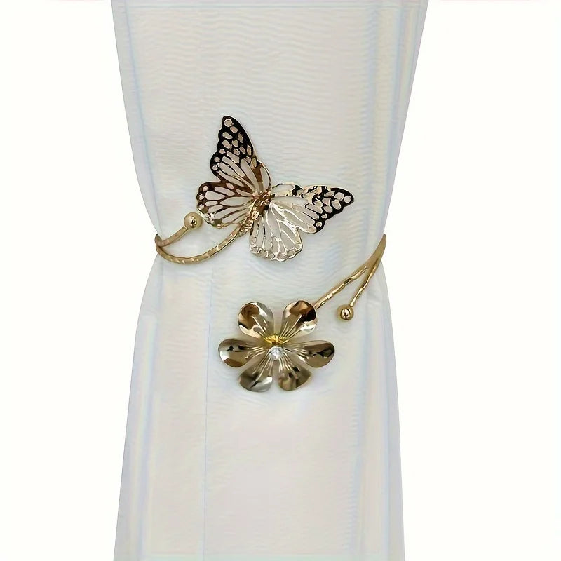 A set of two decorative flower butterfly curtain tiebacks with gold-toned metalwork.
