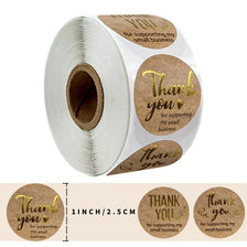 Roll of kraft paper thank you stickers with gold foil text for supporting a small business