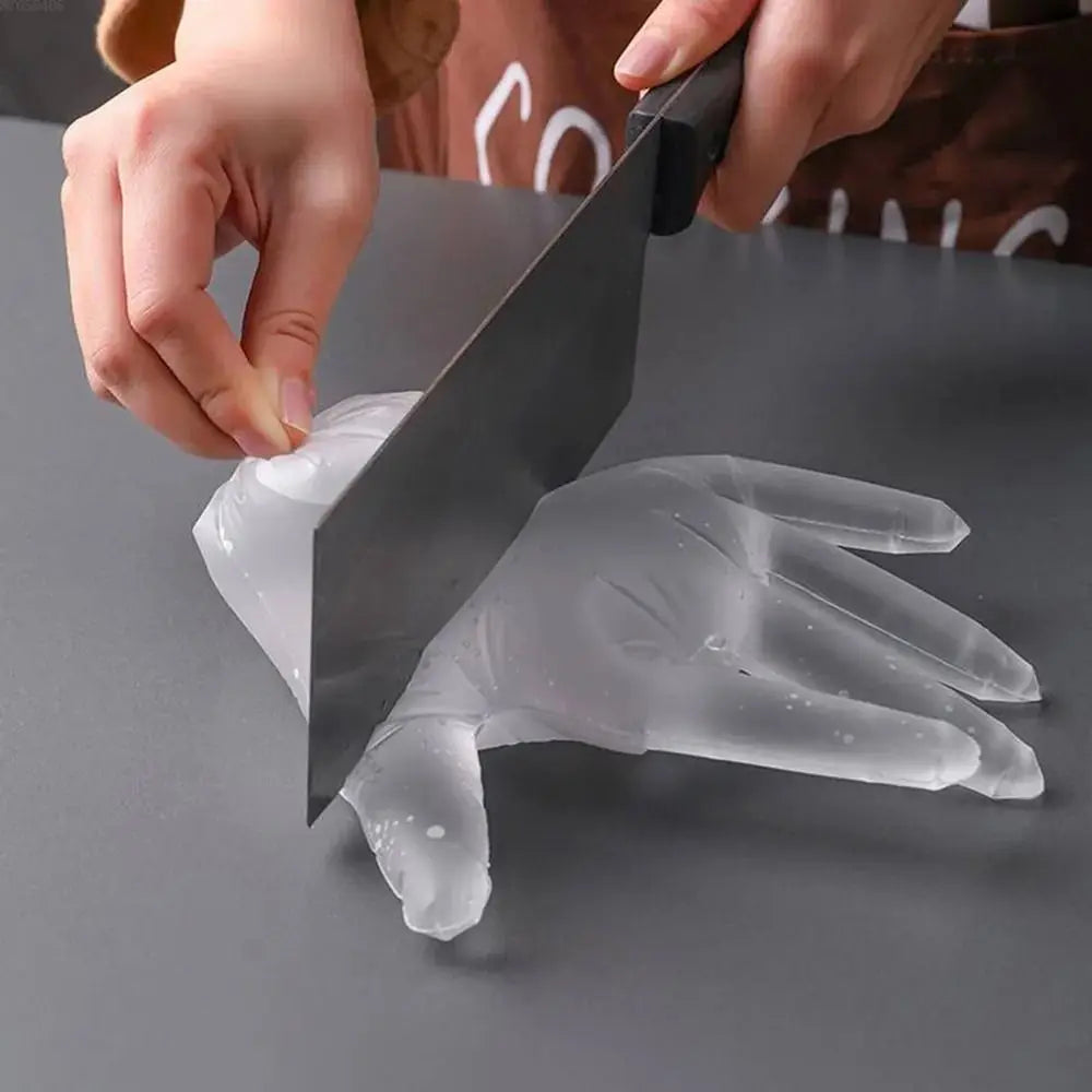 Hands are using a heavy-duty disposable safety glove cutter to cut a clear plastic glove.