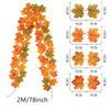 A long artificial vine featuring orange and yellow autumn maple leaves, displayed in various sizes.