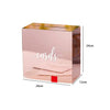 A rectangular pink acrylic gift box with a gold rim and a wooden base, shown in a side view.