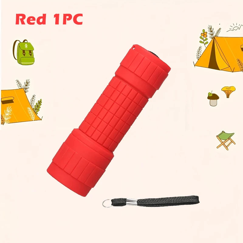 Red 1PC compact flashlight with a black lanyard shown next to camping gear.