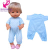 A baby doll wearing a light blue polka dot outfit and hat, shown next to the clothing set.