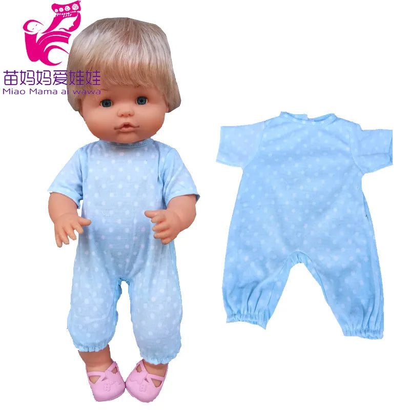 A baby doll wearing a light blue polka dot outfit and hat, shown next to the clothing set.