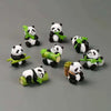 A set of mini resin panda bonsai figurines, some holding green leaves.