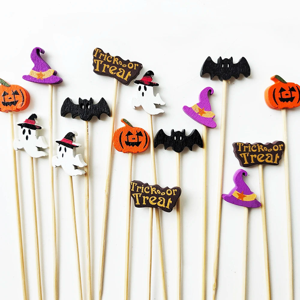 A collection of pearl-tipped bamboo cocktail picks featuring Halloween designs like bats and pumpkins.