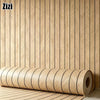 Roll of 3D wood grain self-adhesive wallpaper mounted on a vertical wooden panel.