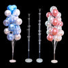 A set of blue and pink balloons displayed on a stand with a base and pole for party decorations.