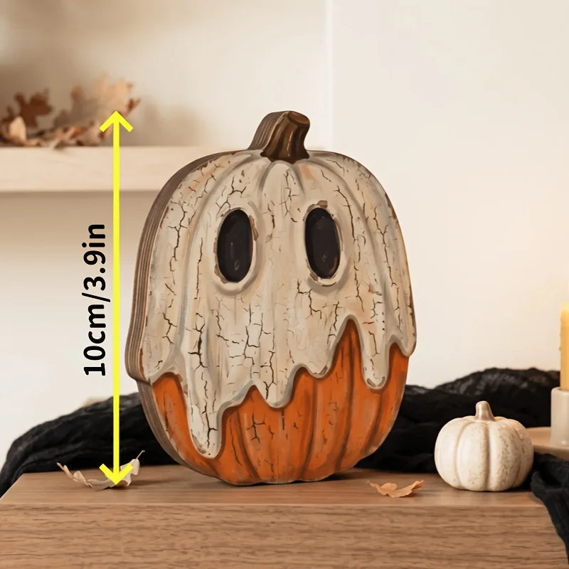 A distressed, orange and white vintage carved pumpkin decoration with a carved face sits on a wooden surface.