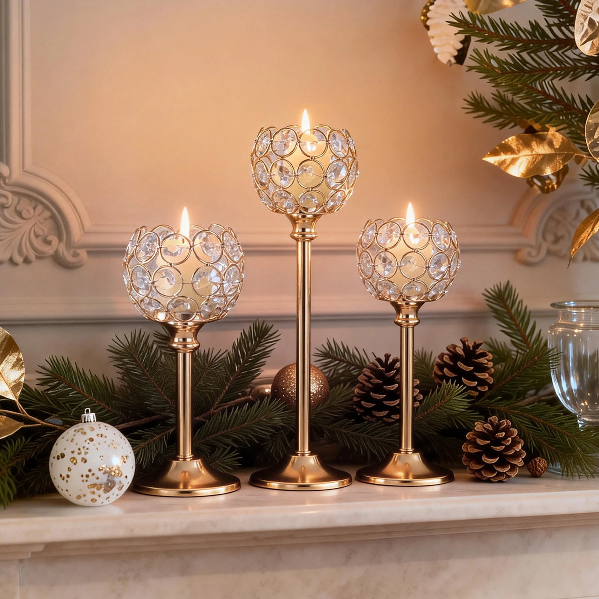 A display of elegant metal glass candle holders and pine greenery on a mantelpiece.