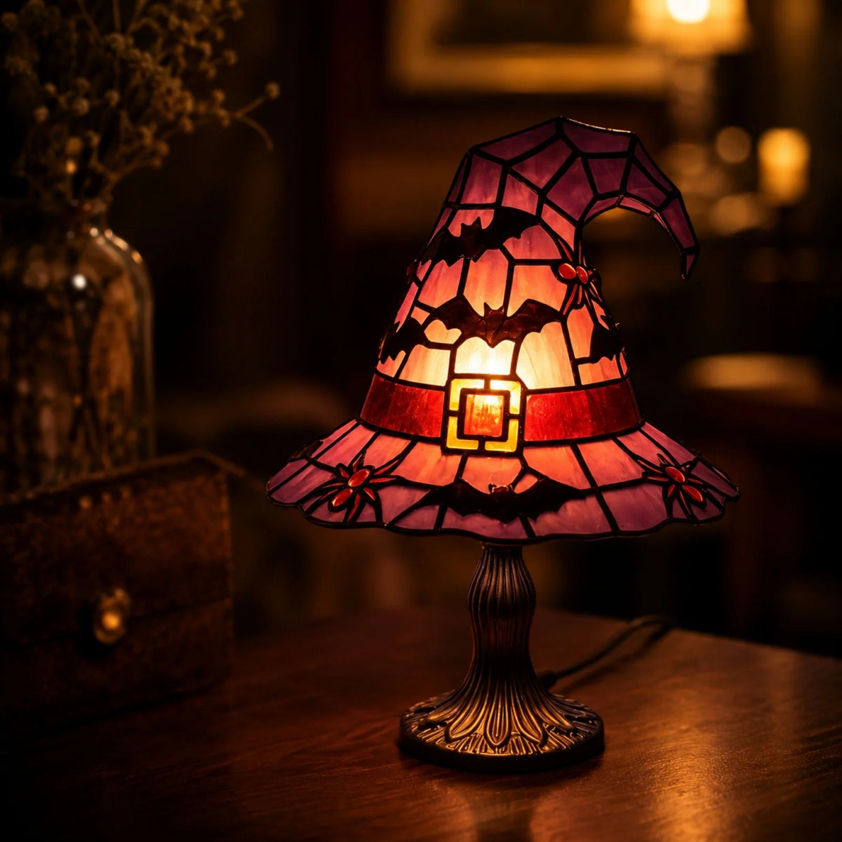 A witch hat night light featuring a stained glass effect in shades of orange, pink, and purple.