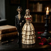 A resin statue of a gothic skeleton couple, featuring a male and female figure in period attire.