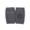 A pair of gray knitted baby socks with a textured pattern.
