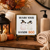 A framed sign with text that reads Wash Your Hands Boo for bathroom decor