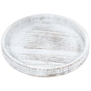 A round, distressed white wooden serving tray with visible grain and rustic edges.