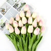 A bouquet of pink and white artificial tulips arranged for decoration.