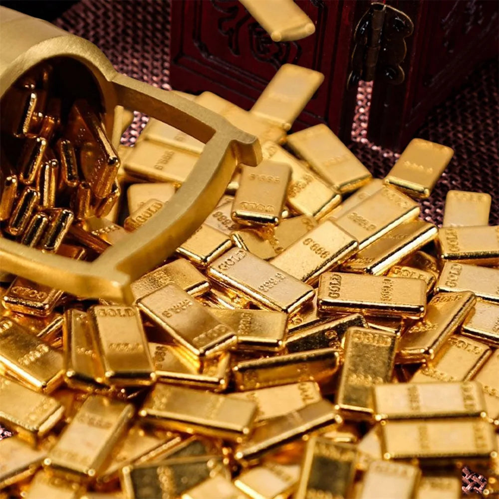 A pile of gold-colored metal prosperity decorations set.
