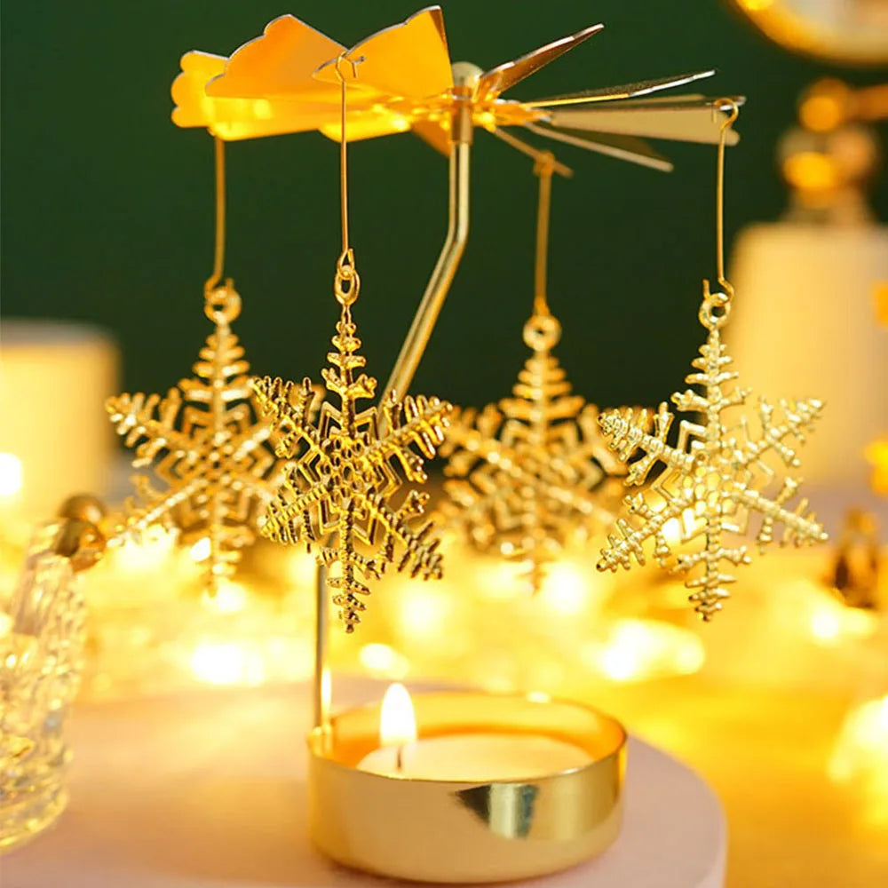 A gold rotating candle holder with a spinning carousel of decorative snowflakes and tealights.