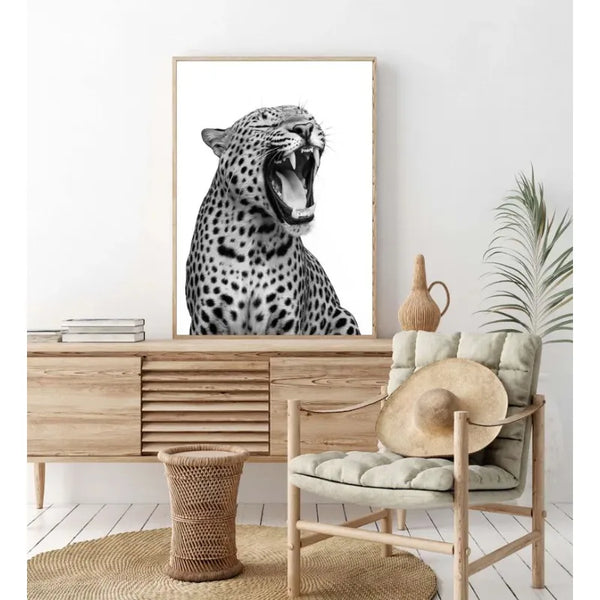 A framed canvas print of a leopard's head in black and white against a white background.